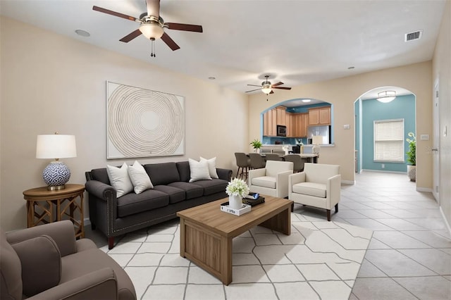 14167 Stilton St, Tampa, FL 33626 - living room featuring ceiling fan, arched walkways, and light tile patterned floors