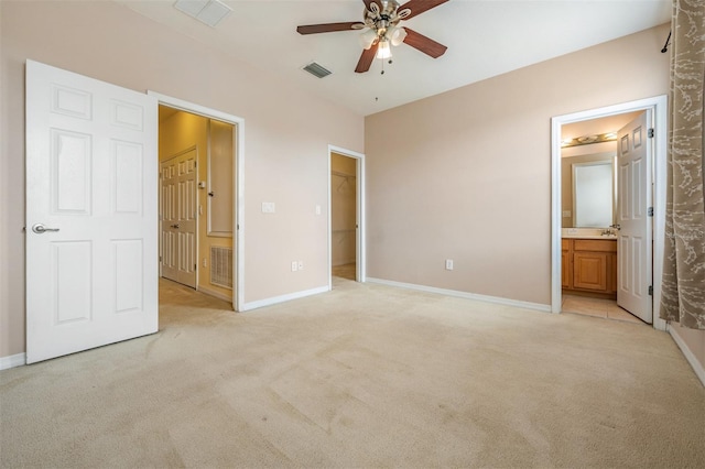 14167 Stilton St, Tampa, FL 33626 - unfurnished bedroom with light carpet, ensuite bath, a walk in closet, and ceiling fan