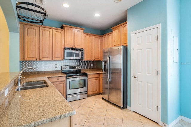 14167 Stilton St, Tampa, FL 33626 - kitchen featuring stainless steel appliances, backsplash, light tile patterned flooring, recessed lighting, and light brown cabinets