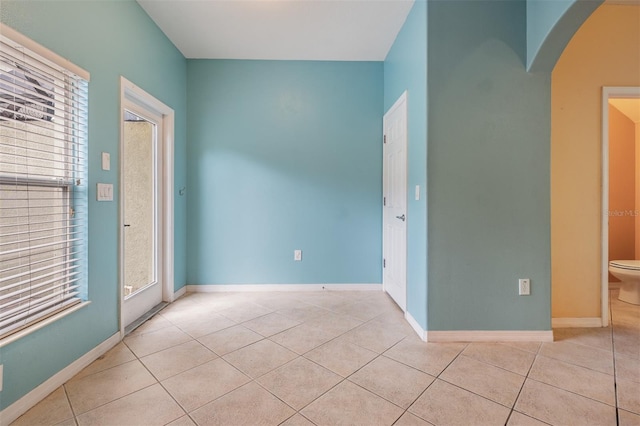 14167 Stilton St, Tampa, FL 33626 - spare room with arched walkways and tile patterned flooring