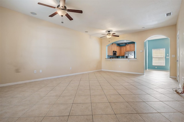 14167 Stilton St, Tampa, FL 33626 - unfurnished living room with a ceiling fan, light tile patterned floors, and arched walkways