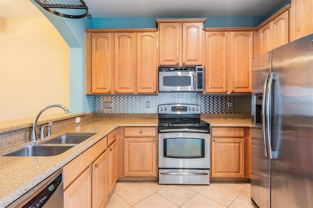 14167 Stilton St, Tampa, FL 33626 - kitchen featuring appliances with stainless steel finishes, light stone countertops, and light brown cabinets