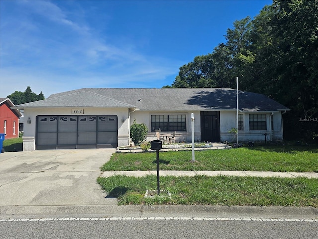 8548 Cypress Lakes Blvd, New Port Richey, FL 34653 - ranch-style house with stucco siding, driveway, an attached garage, and a front yard