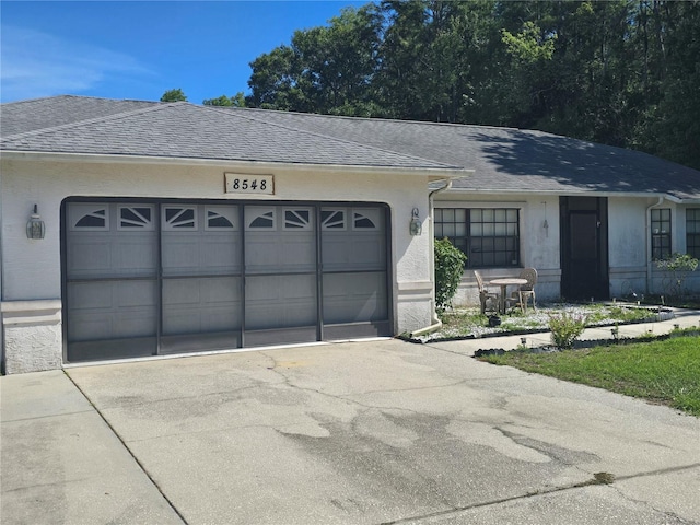8548 Cypress Lakes Blvd, New Port Richey, FL 34653 - single story home with roof with shingles, a garage, and driveway