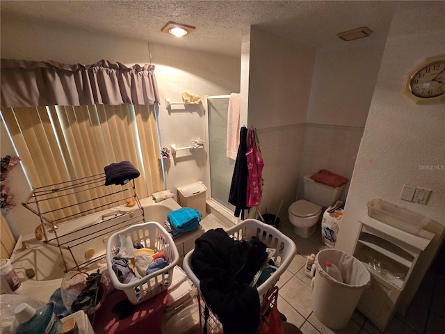 8548 Cypress Lakes Blvd, New Port Richey, FL 34653 - bathroom featuring a textured ceiling, a stall shower, and tile patterned flooring