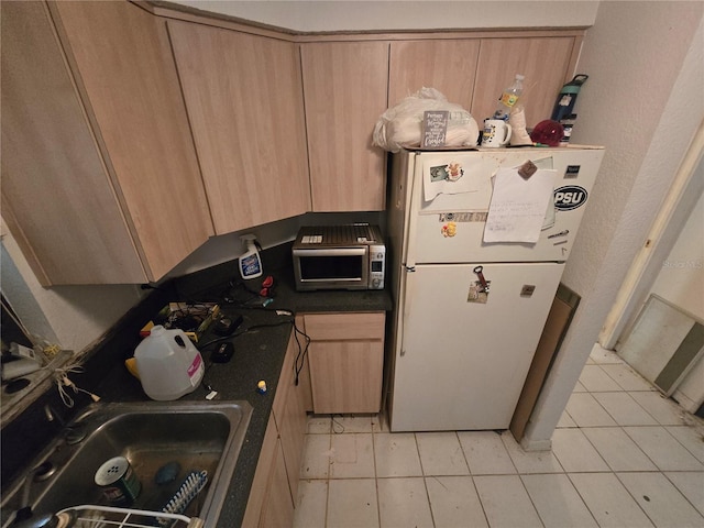8548 Cypress Lakes Blvd, New Port Richey, FL 34653 - kitchen with freestanding refrigerator, light brown cabinets, light tile patterned floors, and stainless steel microwave