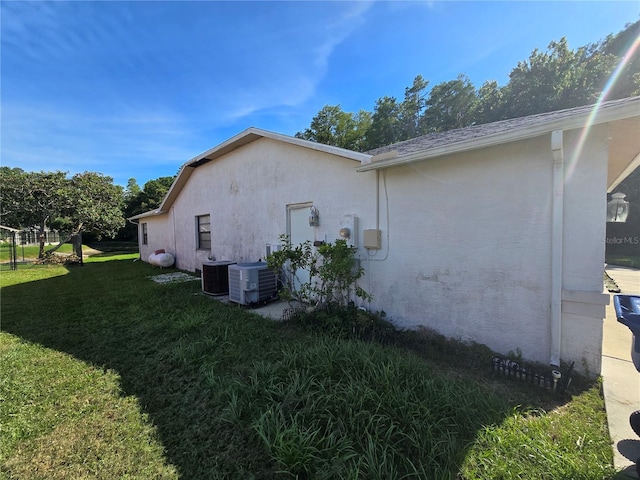 8548 Cypress Lakes Blvd, New Port Richey, FL 34653 - view of property exterior with a yard and stucco siding