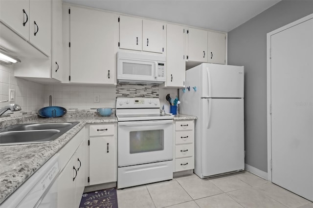 2700 Bayshore Blvd Unit 2312, Dunedin, FL 34698 - kitchen featuring white appliances, light tile patterned flooring, tasteful backsplash, and light countertops