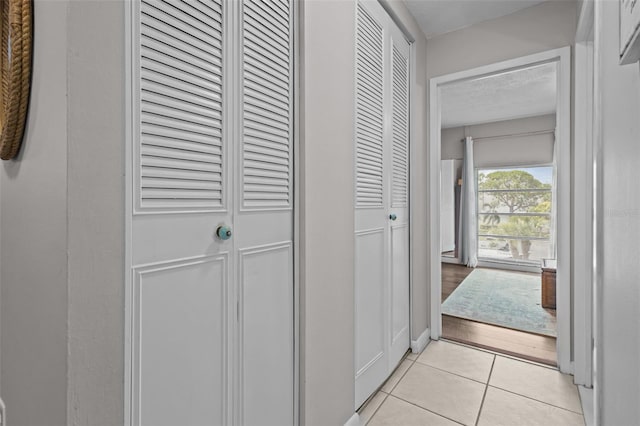 2700 Bayshore Blvd Unit 2312, Dunedin, FL 34698 - hall featuring light tile patterned floors and baseboards