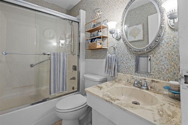 2700 Bayshore Blvd Unit 2312, Dunedin, FL 34698 - full bathroom featuring tile walls, combined bath / shower with glass door, vanity, and wainscoting