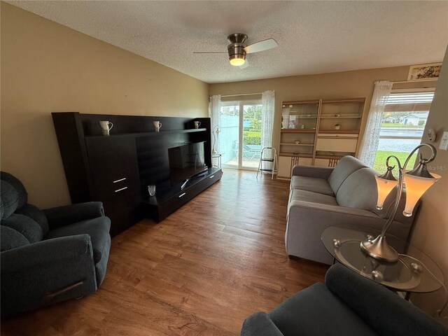 2722 Sherbrooke Ln Unit D, Palm Harbor, FL 34684 - living room with wood finished floors, a textured ceiling, and ceiling fan