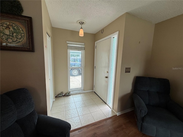 2722 Sherbrooke Ln Unit D, Palm Harbor, FL 34684 - entryway featuring a textured ceiling and light wood-style flooring