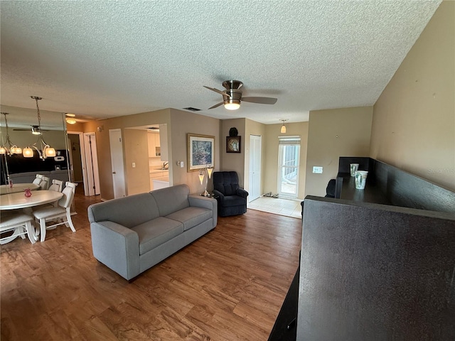 2722 Sherbrooke Ln Unit D, Palm Harbor, FL 34684 - living area with a ceiling fan, wood finished floors, and a textured ceiling
