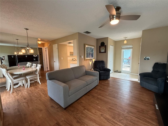 2722 Sherbrooke Ln Unit D, Palm Harbor, FL 34684 - living area featuring a textured ceiling, wood finished floors, and ceiling fan