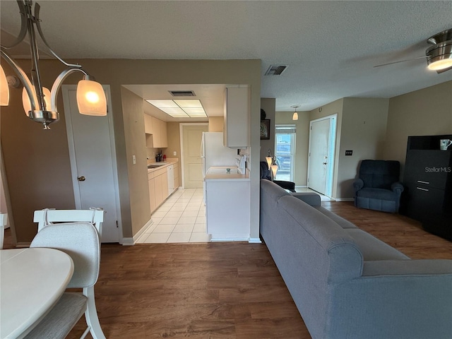 2722 Sherbrooke Ln Unit D, Palm Harbor, FL 34684 - living area featuring light wood-style flooring and baseboards
