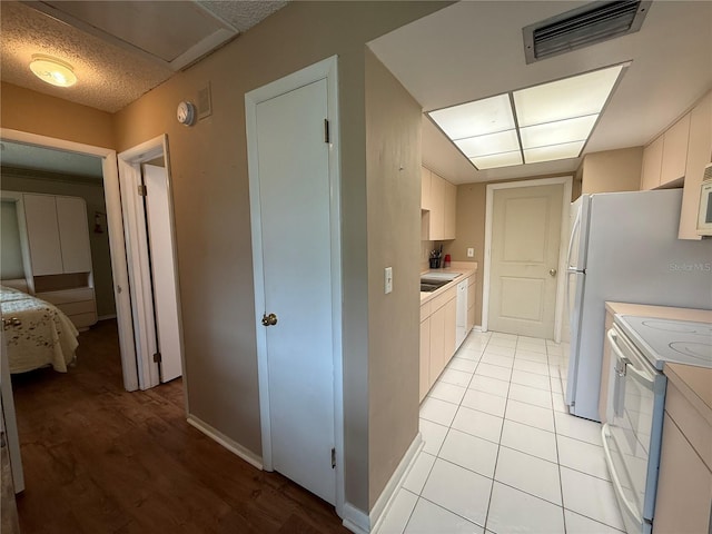 2722 Sherbrooke Ln Unit D, Palm Harbor, FL 34684 - kitchen featuring white appliances, light countertops, and white cabinetry