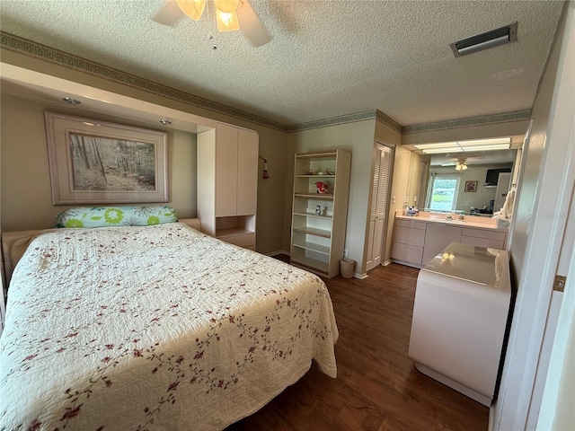 2722 Sherbrooke Ln Unit D, Palm Harbor, FL 34684 - bedroom featuring dark wood-type flooring, a textured ceiling, a ceiling fan, and a closet