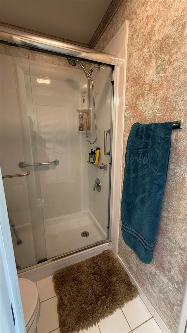 2722 Sherbrooke Ln Unit D, Palm Harbor, FL 34684 - bathroom featuring a stall shower, tile patterned flooring, and wallpapered walls