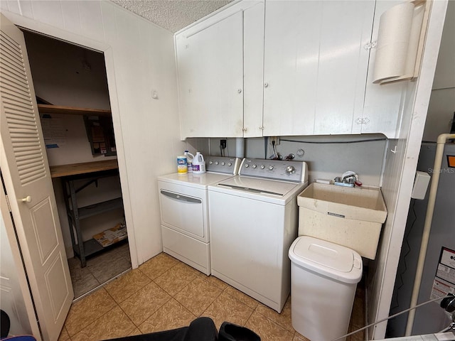 2722 Sherbrooke Ln Unit D, Palm Harbor, FL 34684 - washroom with washer and dryer, cabinet space, a textured ceiling, and light tile patterned floors