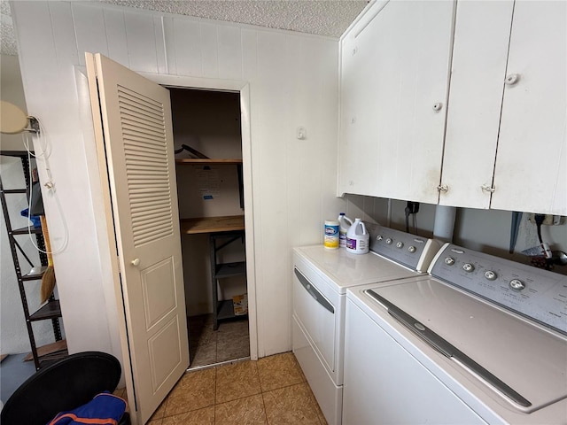 2722 Sherbrooke Ln Unit D, Palm Harbor, FL 34684 - laundry room with separate washer and dryer, cabinet space, a textured ceiling, and light tile patterned floors