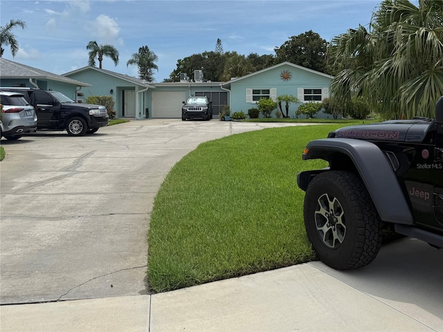 2722 Sherbrooke Ln Unit D, Palm Harbor, FL 34684 - view of grassy yard featuring driveway and a garage