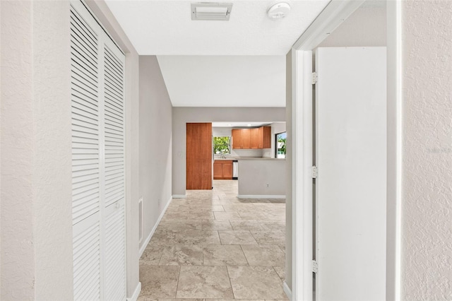 2986 Cypress Green Dr, Palm Harbor, FL 34684 - hallway featuring baseboards and stone finish floors