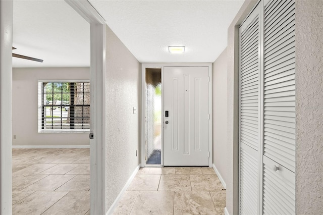 2986 Cypress Green Dr, Palm Harbor, FL 34684 - foyer entrance with a textured wall, light tile patterned floors, and a textured ceiling