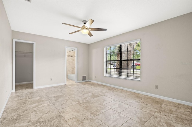 2986 Cypress Green Dr, Palm Harbor, FL 34684 - unfurnished bedroom with a walk in closet, a closet, ensuite bathroom, and ceiling fan