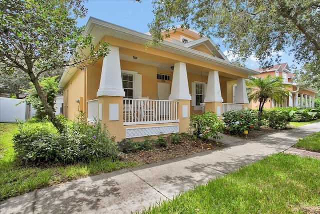 7310 S Shamrock Rd, Tampa, FL 33616 - view of front facade with covered porch and stucco siding