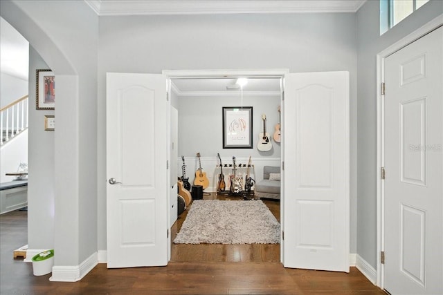 7310 S Shamrock Rd, Tampa, FL 33616 - hall with crown molding, dark wood finished floors, arched walkways, and stairs
