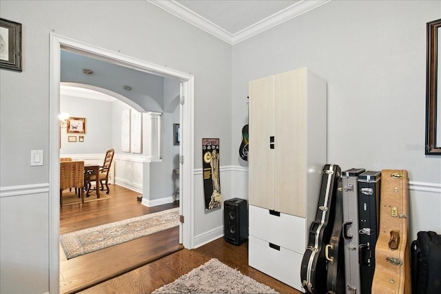 7310 S Shamrock Rd, Tampa, FL 33616 - interior space featuring ornamental molding, dark wood finished floors, arched walkways, and decorative columns