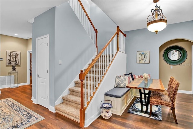 7310 S Shamrock Rd, Tampa, FL 33616 - stairway featuring arched walkways, wood finished floors, and recessed lighting