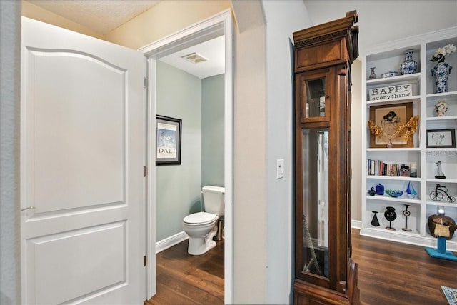 7310 S Shamrock Rd, Tampa, FL 33616 - bathroom with wood finished floors and toilet