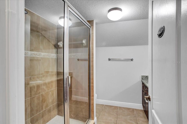 7310 S Shamrock Rd, Tampa, FL 33616 - full bath with a textured ceiling, a stall shower, vanity, and tile patterned floors