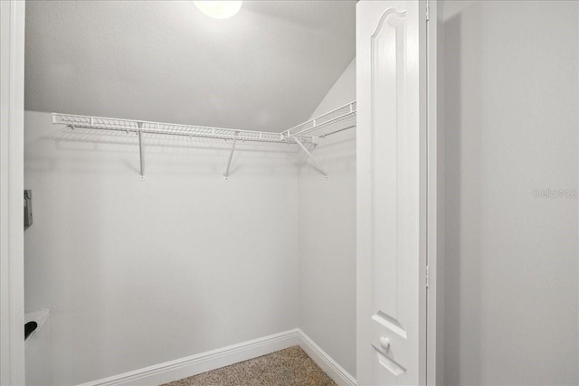 7310 S Shamrock Rd, Tampa, FL 33616 - walk in closet featuring vaulted ceiling
