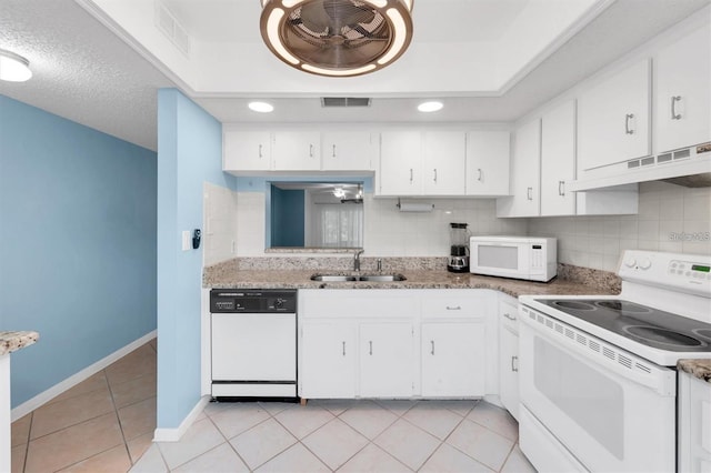 845 Maple Ct Unit 103, Dunedin, FL 34698 - kitchen featuring white appliances, under cabinet range hood, tasteful backsplash, and white cabinetry