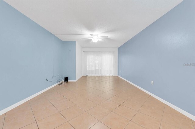 845 Maple Ct Unit 103, Dunedin, FL 34698 - unfurnished room with light tile patterned floors, ceiling fan, and a textured ceiling