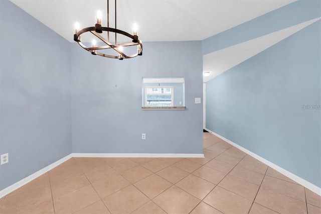 845 Maple Ct Unit 103, Dunedin, FL 34698 - tiled spare room with a chandelier and baseboards