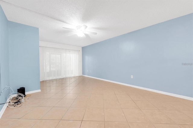 845 Maple Ct Unit 103, Dunedin, FL 34698 - empty room featuring a ceiling fan, light tile patterned flooring, and a textured ceiling