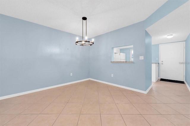 845 Maple Ct Unit 103, Dunedin, FL 34698 - unfurnished room featuring a chandelier and light tile patterned flooring