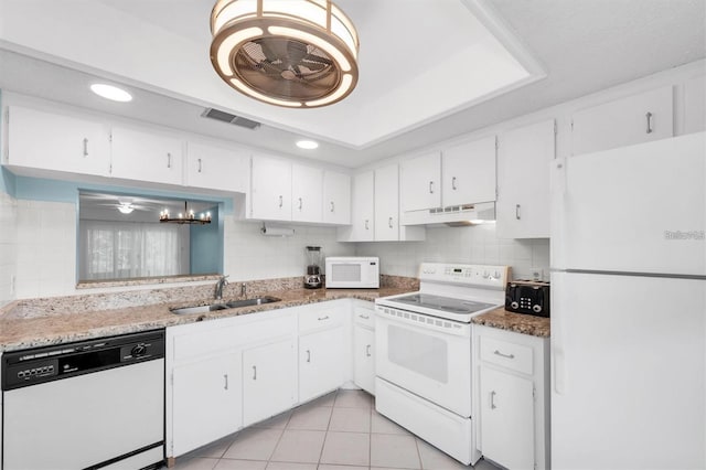 845 Maple Ct Unit 103, Dunedin, FL 34698 - kitchen with white appliances, under cabinet range hood, tasteful backsplash, white cabinetry, and recessed lighting
