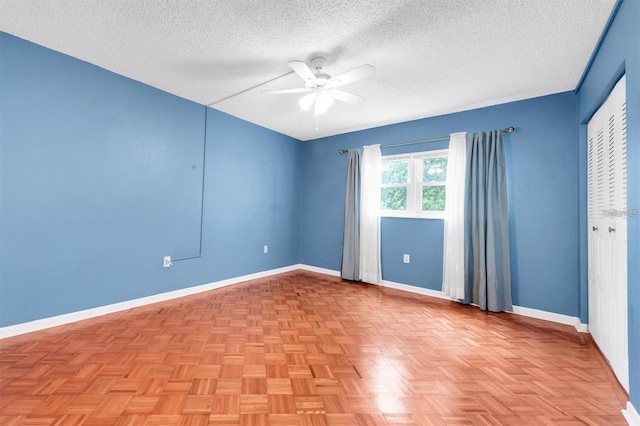 845 Maple Ct Unit 103, Dunedin, FL 34698 - empty room featuring ceiling fan and a textured ceiling