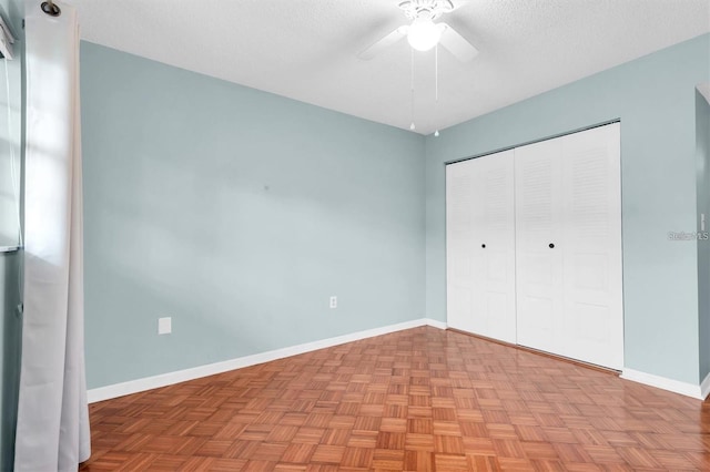 845 Maple Ct Unit 103, Dunedin, FL 34698 - unfurnished bedroom with a closet, a textured ceiling, and ceiling fan