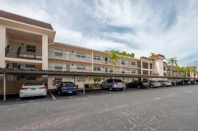 845 Maple Ct Unit 103, Dunedin, FL 34698 - view of property featuring covered parking