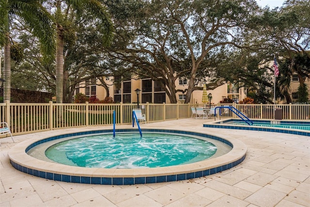 845 Maple Ct Unit 103, Dunedin, FL 34698 - view of swimming pool featuring a community hot tub and a patio