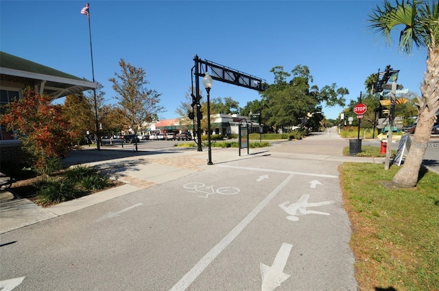 845 Maple Ct Unit 103, Dunedin, FL 34698 - view of asphalt road featuring street lighting, traffic signs, and sidewalks