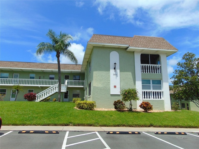 1250 S Pinellas Ave Unit 307, Tarpon Springs, FL 34689 - view of property featuring uncovered parking and stairway