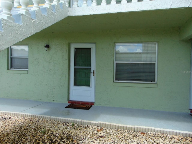 1250 S Pinellas Ave Unit 307, Tarpon Springs, FL 34689 - doorway to property featuring stucco siding