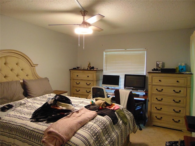 1250 S Pinellas Ave Unit 307, Tarpon Springs, FL 34689 - bedroom featuring light colored carpet, a textured ceiling, and a ceiling fan
