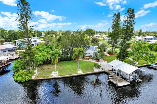 102 W N Branch Rd, Ruskin, FL 33570 - dock with boat lift, a water view, view of scattered trees, and a yard